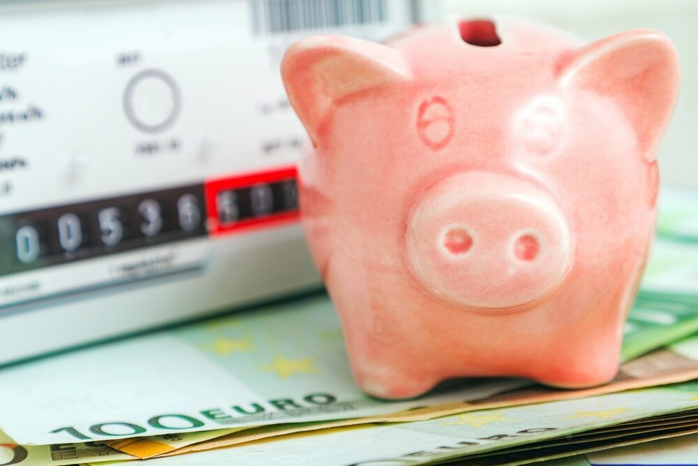 Pink,Piggy,Bank,Near,A,Domestic,Gas,Meter,At,Home.