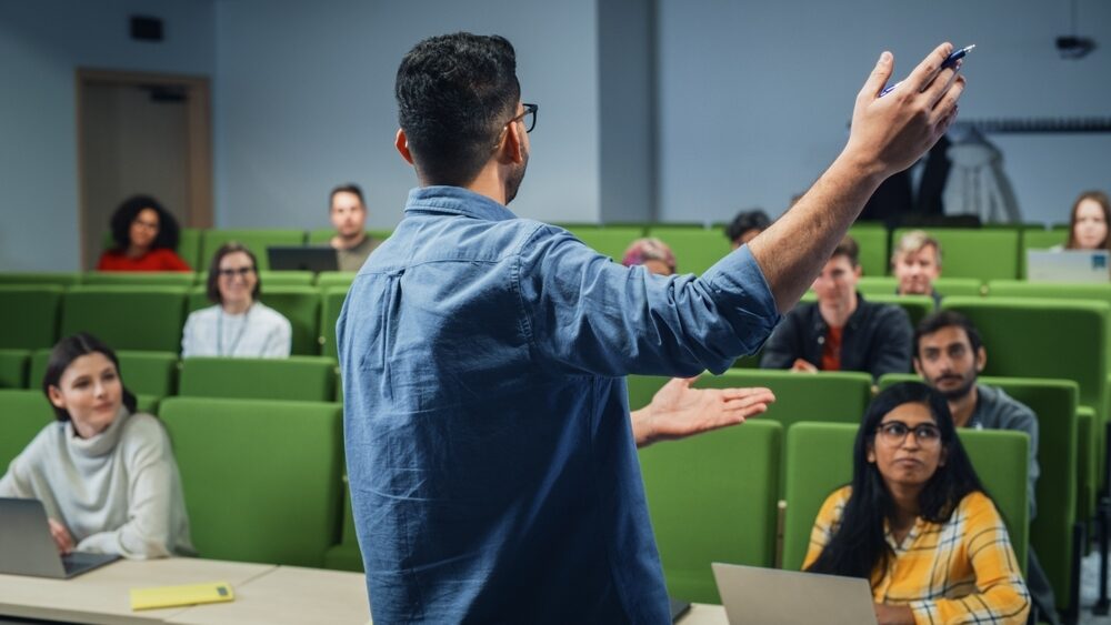 Male,Teacher,Giving,A,Lecture,To,A,Diverse,Multiethnic,Group